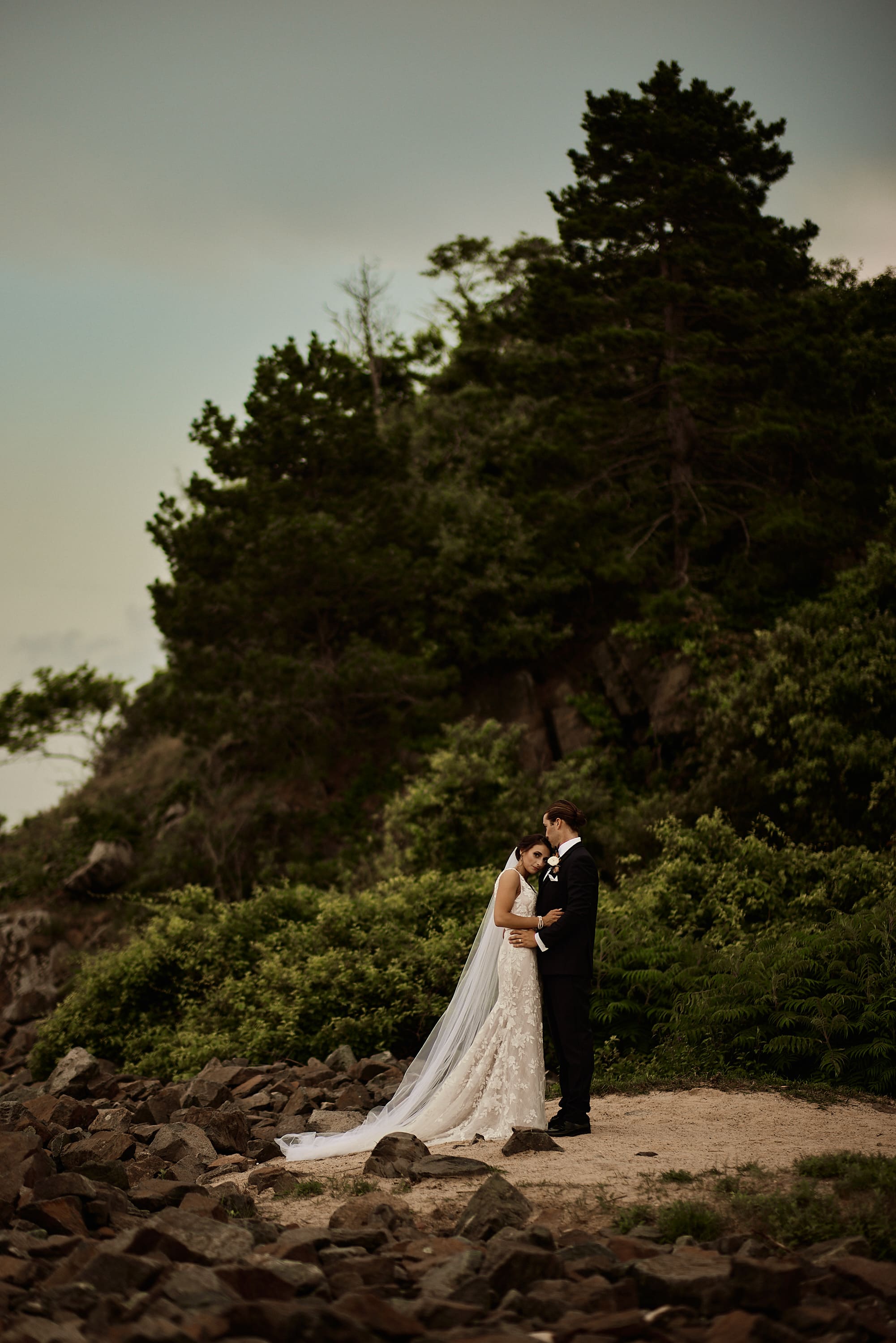Wide cinematic portrait of a couple on a cliffside by the ocean